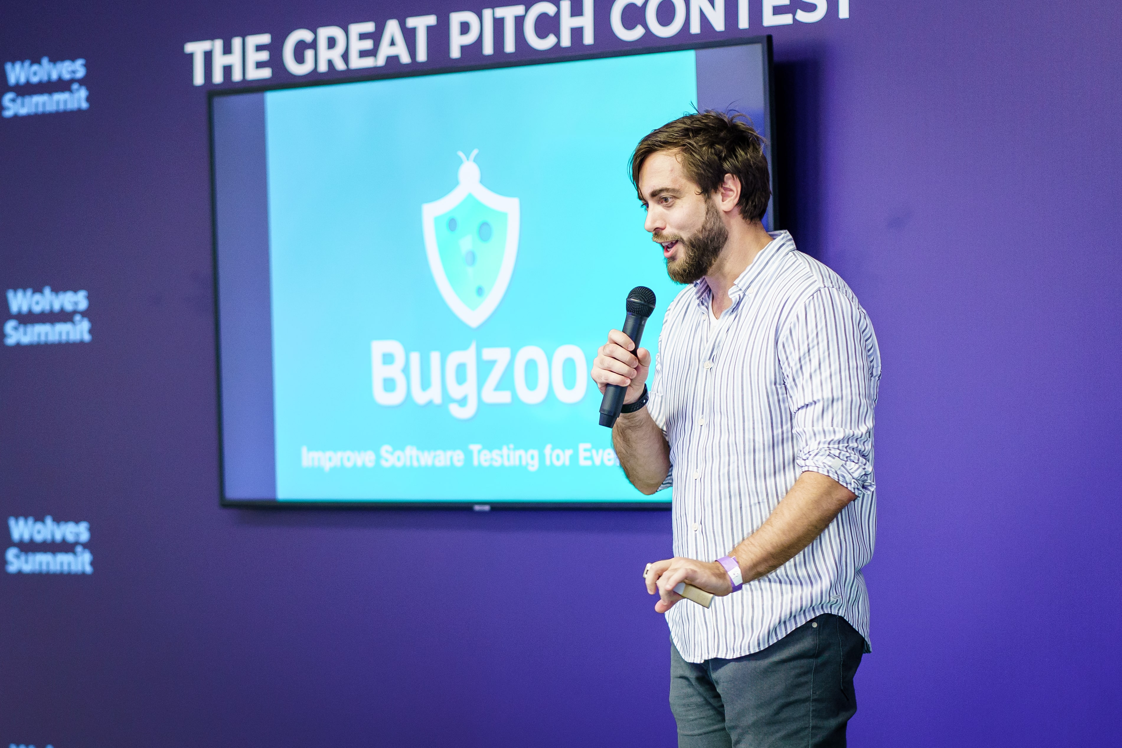 A man pitching in front of investors.